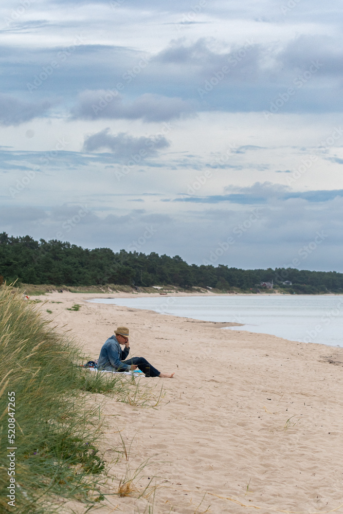 A man sitting alone on beach