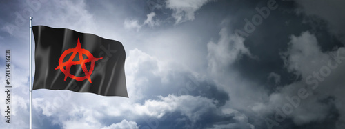 Anarchy flag on a cloudy sky photo