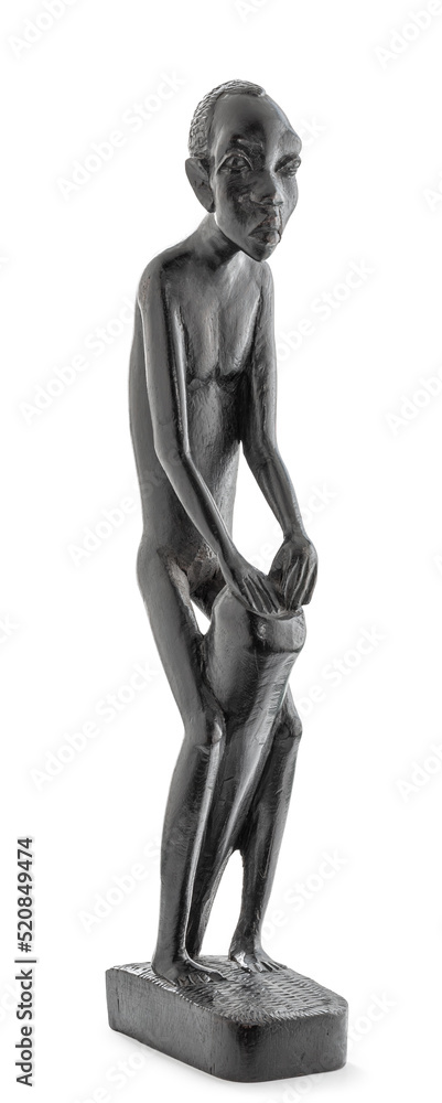 Wooden African statue of a skinny man working playing percussion, isolated on white Wooden African statue of a skinny man working playing percussion, isolated on white