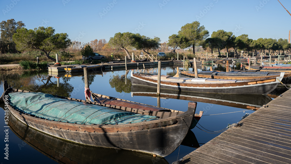 BOATS MOORED ON THE LAKE ON A SUNNY DAY