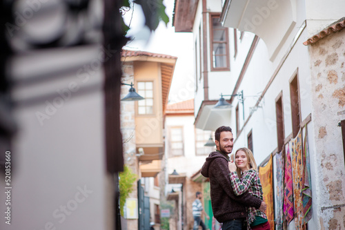 Young couple hugging outdoors in old European town