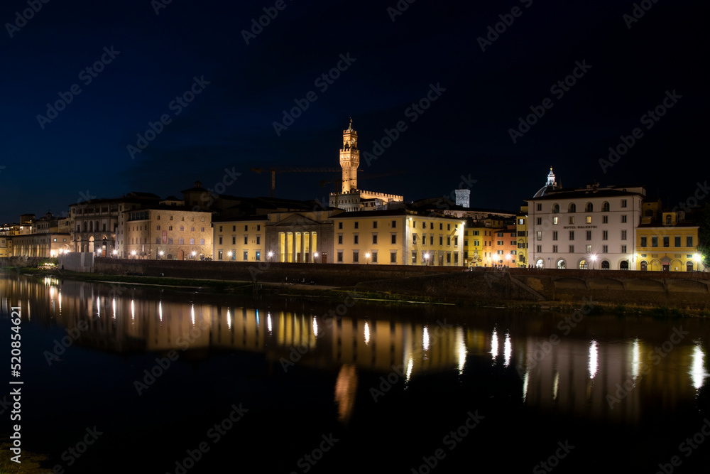 City lights reflected over the arno river at night, Florence, Italy