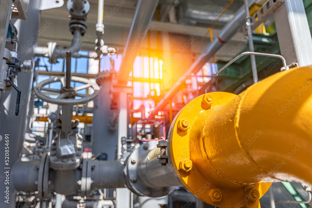 Steel pipelines and equipment of factory power plant, background industrial zone, blue toning and sunlight. Steel pipelines and equipment of factory power plant, background industrial zone, blue toning and sunlight.