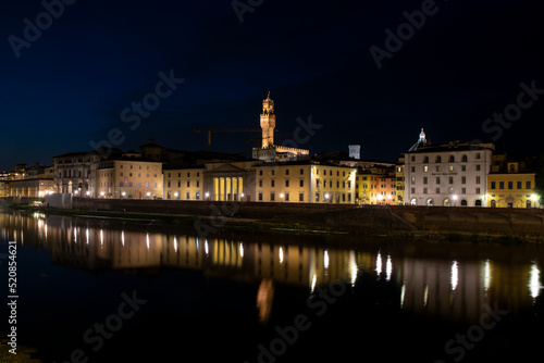 City lights reflected over the arno river at night, Florence, Italy