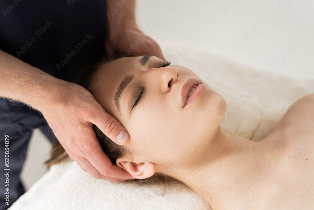 relaxed young woman on facial massage by specialist relaxed young woman on facial massage by specialist