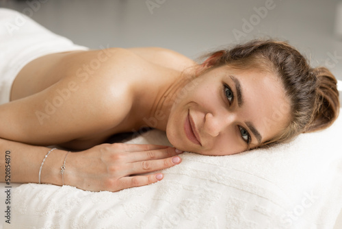 portrait of a beautiful young woman on a massage table