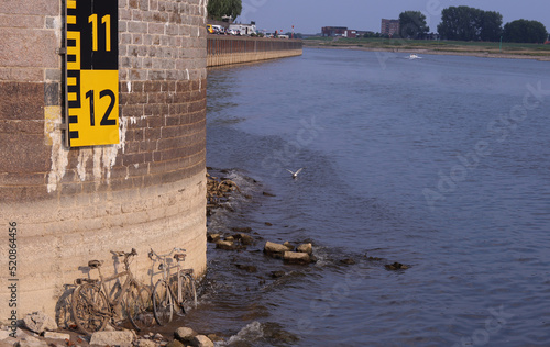 Very low water in the river Rhine reveals some old bikes in the river. photo