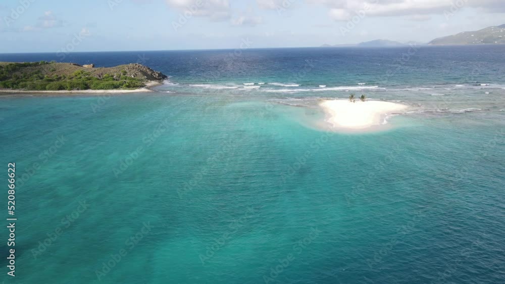 An aerial shot of a beautifully white sand palm tree island in the middle of the Caribbean An aerial shot of a beautifully white sand palm tree island in the middle of the Caribbean