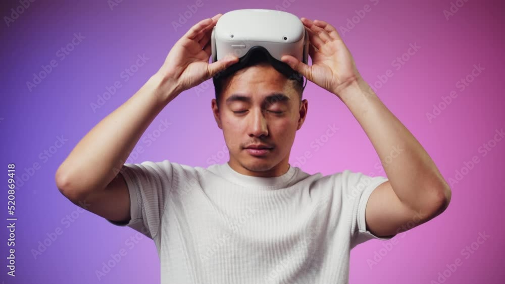 Korean man using virtual reality glasses, playing video games, Asian guy wearing new generation gaming headset for entertainment, amusement park, future technology concept. Korean man using virtual reality glasses, playing video games, Asian guy wearing new generation gaming headset for entertainment, amusement park, future technology concept.
