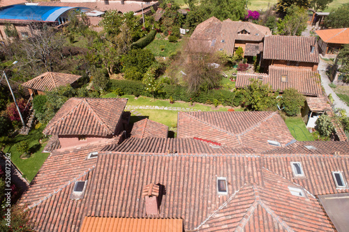 Aerial view of a rural house in the countryside of Cusco Peru. House in Yucay town with roof tiles.
