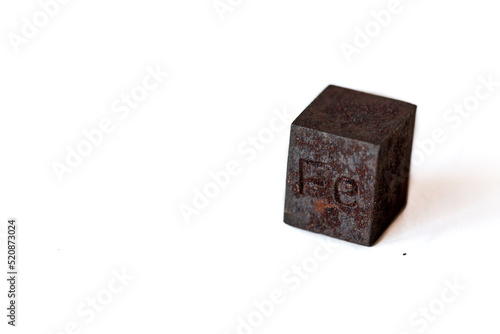 Iron cube with element name Fe on it on white background