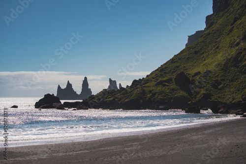 The coast of Reynisfjara Beach - basalt sea stacks in Black Sand Beach