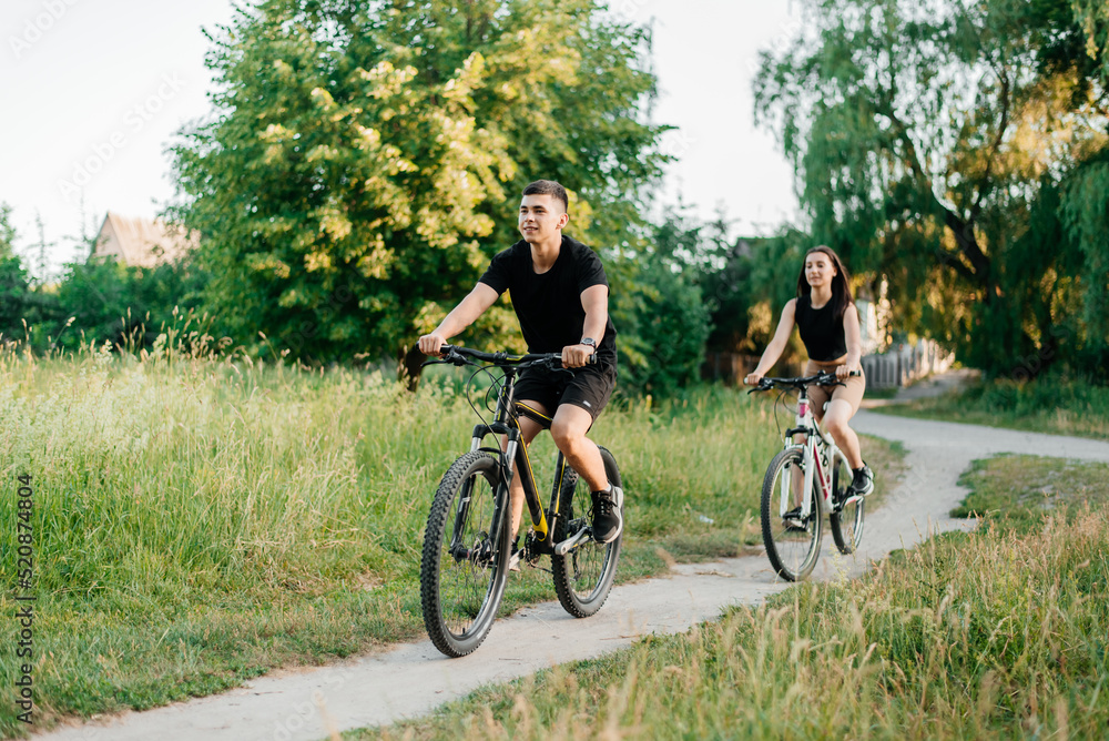 Couple riding bicycles rides on paths in the forest