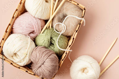 Craft hobby background with yarn in natural colors. Recomforting hobby to reduce stress for cold fall and winter weather. Mock up, copy space, top view