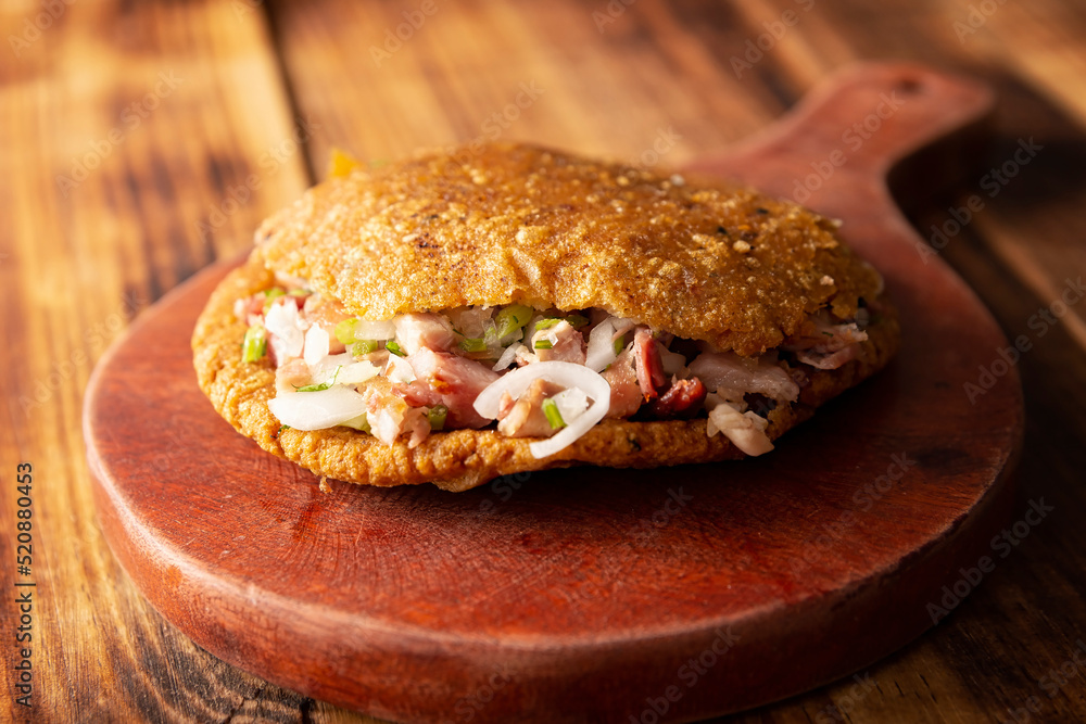 Gordita de Carnitas. Cornmeal dough stuffed with deep fried pork