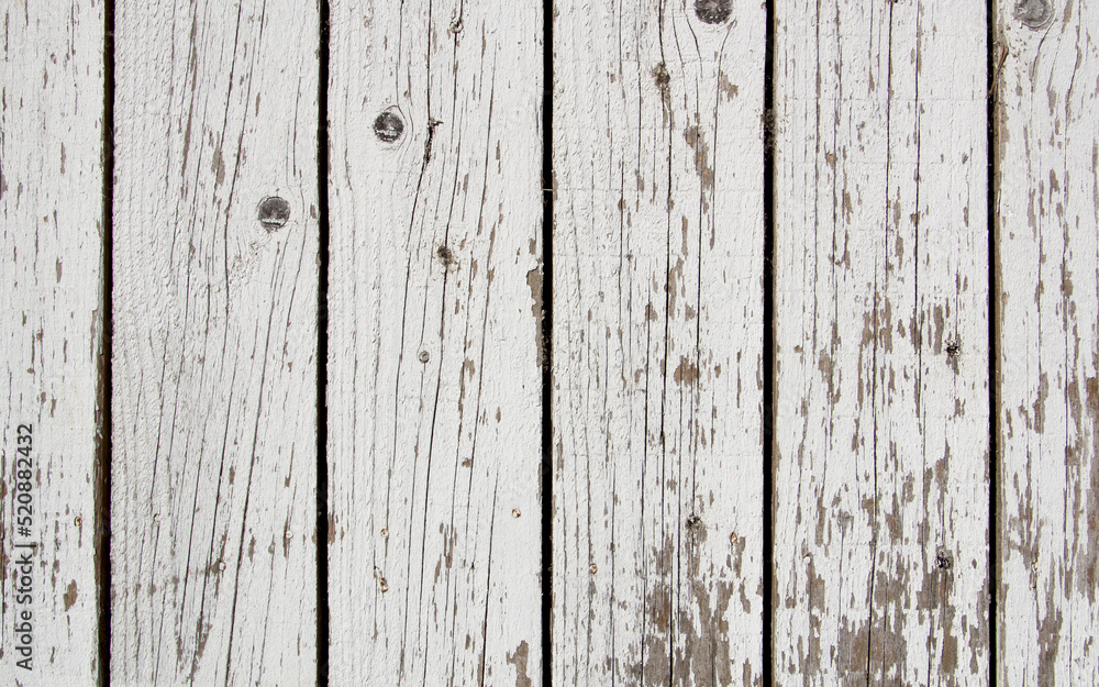 Background - old white fence made of wooden vertical boards.