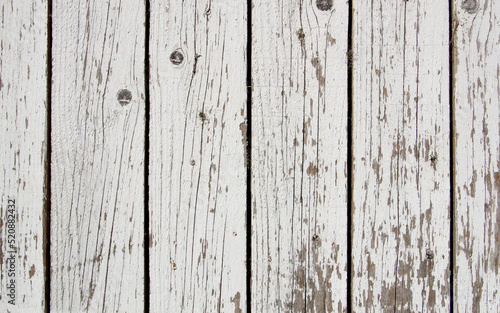 Background - old white fence made of wooden vertical boards.