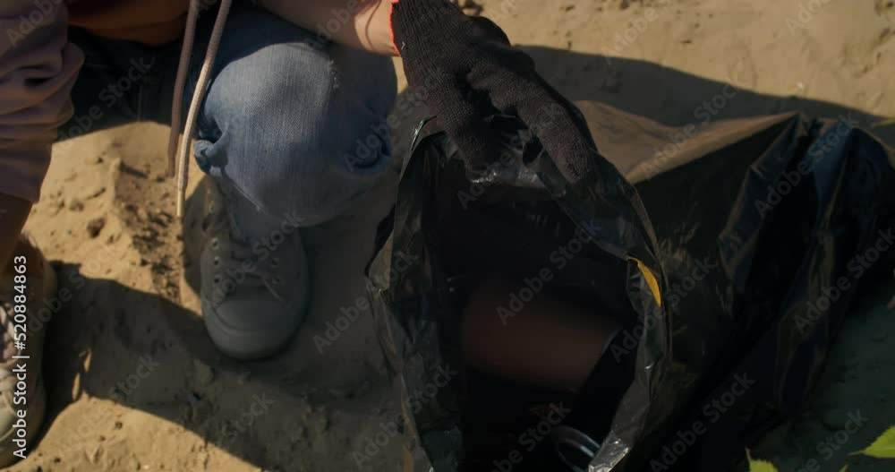Collect plastic garbage in bags, clean up plastic bottles. Environmental problems. Volunteer cleaning up plastic trash on beach. Garbage pollution Collect plastic garbage in bags, clean up plastic bottles. Environmental problems. Volunteer cleaning up plastic trash on beach. Garbage pollution