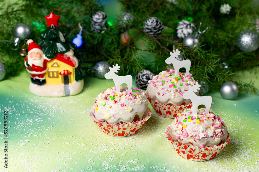 Festive Christmas muffins with icing and sugar sprinkles Festive Christmas muffins with icing and sugar sprinkles