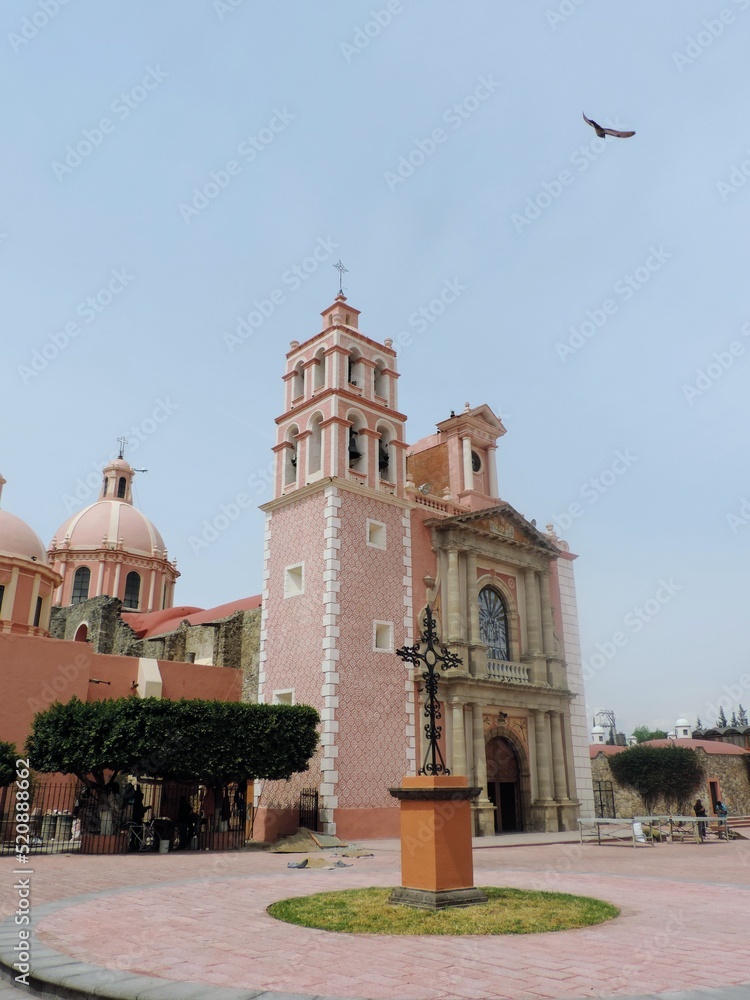 Mexican church, iron cross and bird
