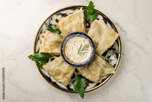 Hanum with sour cream Uzbek cuisine top view on marble table photo