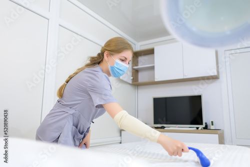 the master of electrolysis prepares the couch before the procedure for removing unwanted hair