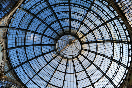 Looking at the dome-like roof structure of Galleria Vittorio Emanuele in Milan, Italy. 19th-century building. Historical Italian building. Traditional steel construction.