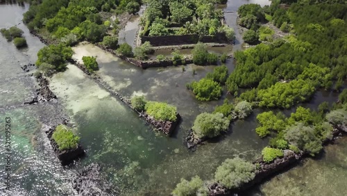 Aerial footage of Nan Madol prehistoric ruined stone city built of basalt slabs. Ancient walls built on artificial islands in the lagoon of Pohnpei, Micronesia, Oceania.