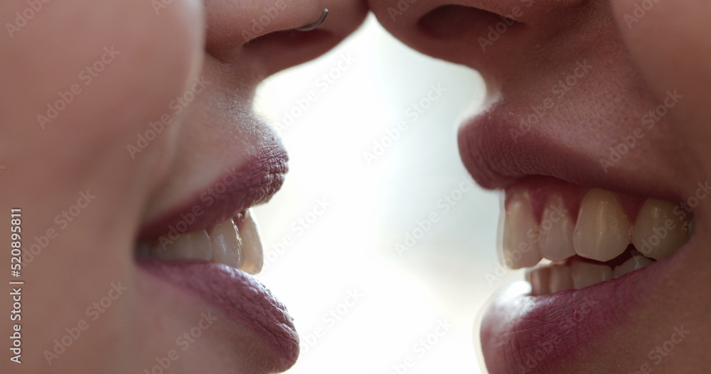 Obraz premium Closeup of Lesbian couple mouth talking to each other gossiping and in conversation