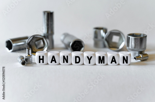 On a white background, a set with tools and white cubes with the inscription - handyman