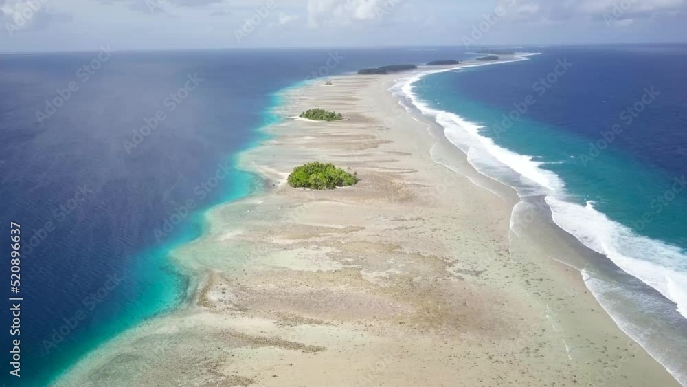 Majuro, Marshall Islands. Small tropical uninhabited island in the middle of the pacific ocean. Atoll with beautiful sandy beach surrounded by coral reef with palm trees. Aerial footage Majuro, Marshall Islands. Small tropical uninhabited island in the middle of the pacific ocean. Atoll with beautiful sandy beach surrounded by coral reef with palm trees. Aerial footage