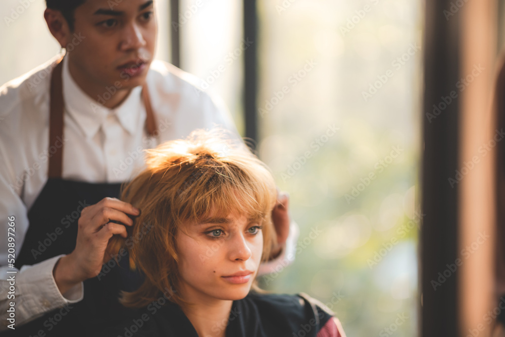 Fototapeta premium concept of professional fashion hairdresser and hair beauty salon, hairstylist making treatment to woman client person, by using scissors for haircut and coiffure care, girl style in studio lifestyle