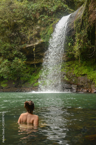 Young woman swimming at Garapia Cascade in Maquine  Rio Grande do Sul  Brazil