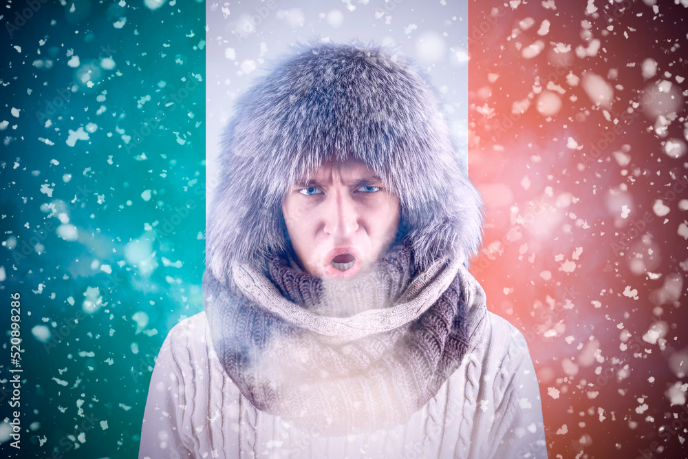 Isolate. Cold weather. Bask. A man in a fur hat and scarf warms his hands with his mouth. It's winter time Isolate. Cold weather. Bask. A man in a fur hat and scarf warms his hands with his mouth. It's winter time
