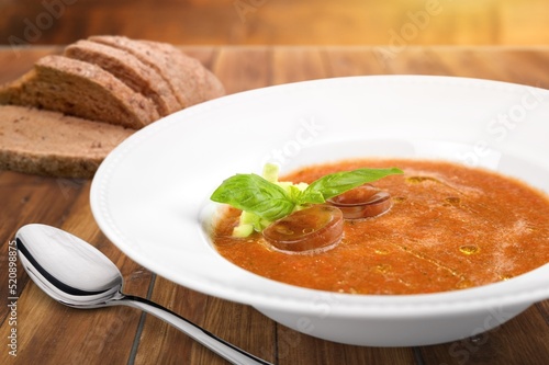 Bowl with tasty soup on wooden background