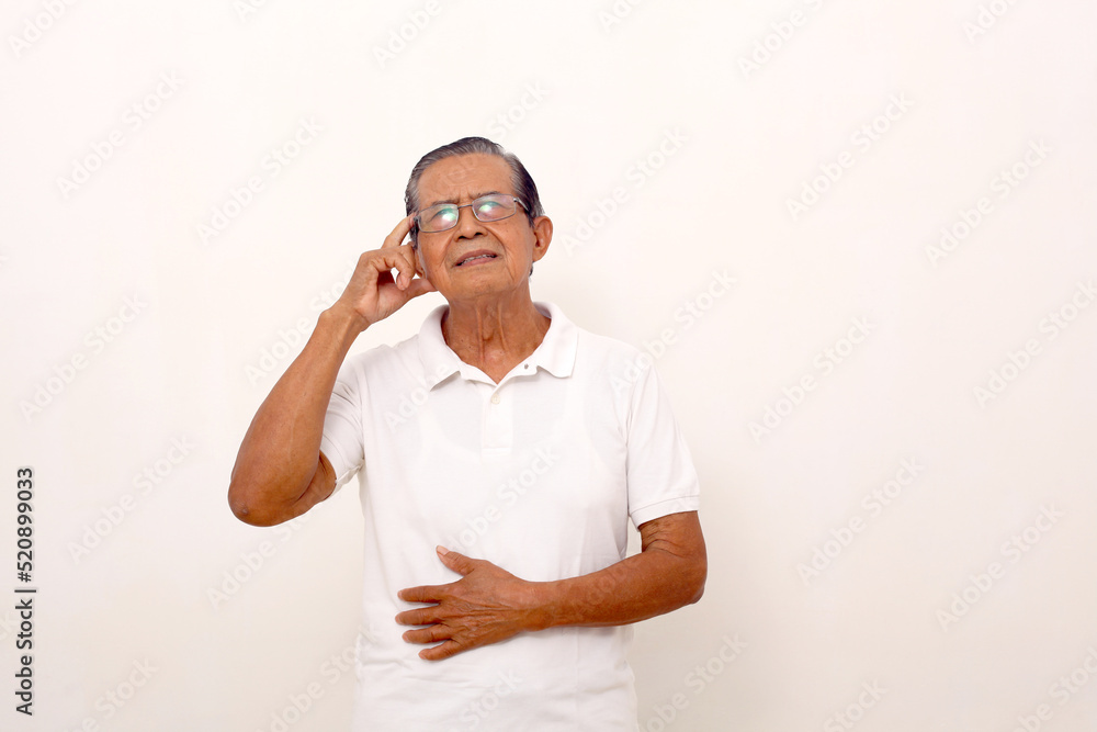 Thoughtful asian old man standing while touching head and looking up. Isolated on white background. Thoughtful asian old man standing while touching head and looking up. Isolated on white background.