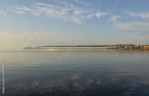 Walk at dawn along the embankment of the city of Kerch  Russia  summer morning seascape  view of the Crimean bridge  the concept of travel and recreation.