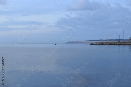 Walk at dawn along the embankment of the city of Kerch, Russia, summer morning seascape, view of the Crimean bridge, the concept of travel and recreation. © m7_ir7