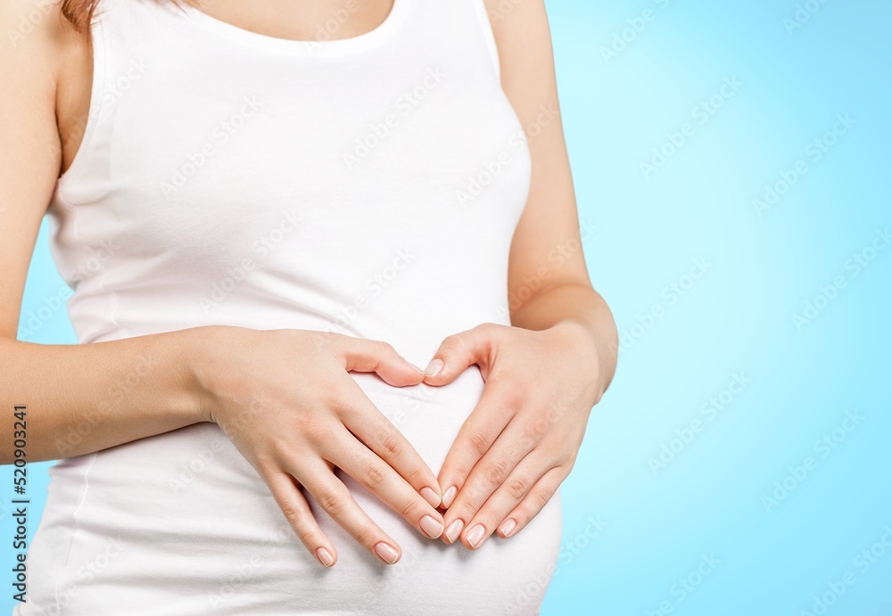 custom made wallpaper toronto digitalYoung healthy woman hand made heart shape on her stomach. Concept of good digestive, healthy gut, probiotics, slim fit, gynecology and woman health care.