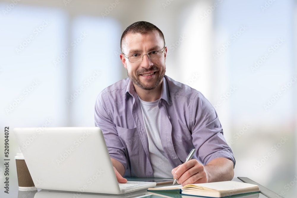 Satisfied man looking at computer screen, reading good news in email, chatting in social network with friends, freelancer blogger working on online project Satisfied man looking at computer screen, reading good news in email, chatting in social network with friends, freelancer blogger working on online project