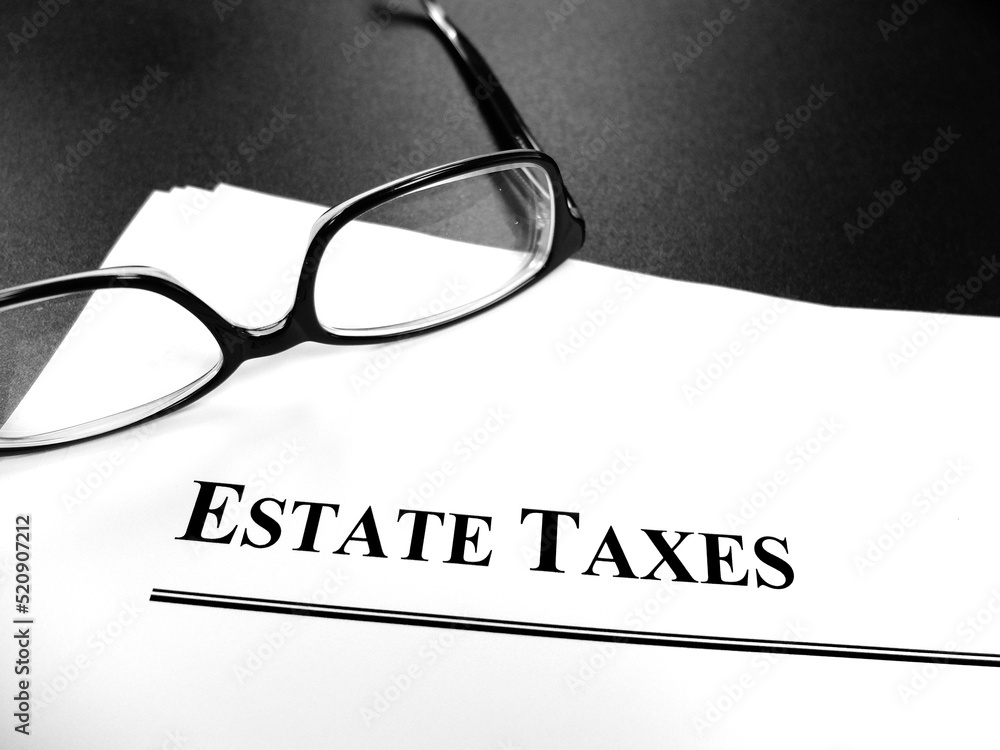 Estate Tax Taxes Documents on Desk with Glasses Estate Tax Taxes Documents on Desk with Glasses