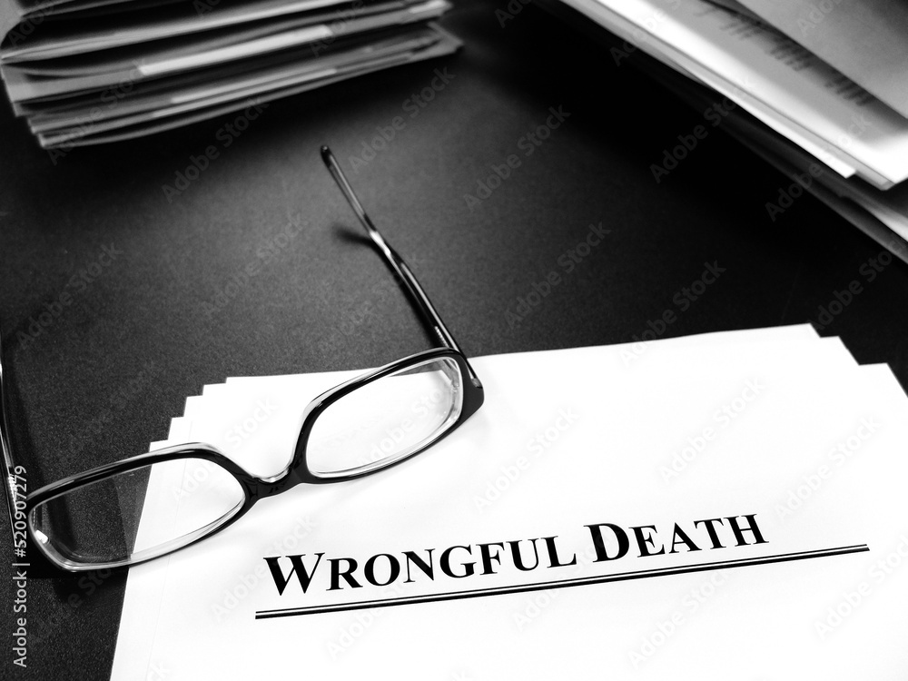 Wrongful Death Papers on Desk for Lawsuit with Glasses Wrongful Death Papers on Desk for Lawsuit with Glasses