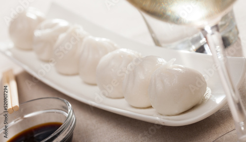 Delicious Chinese dish - steamed dim sum served on platter photo