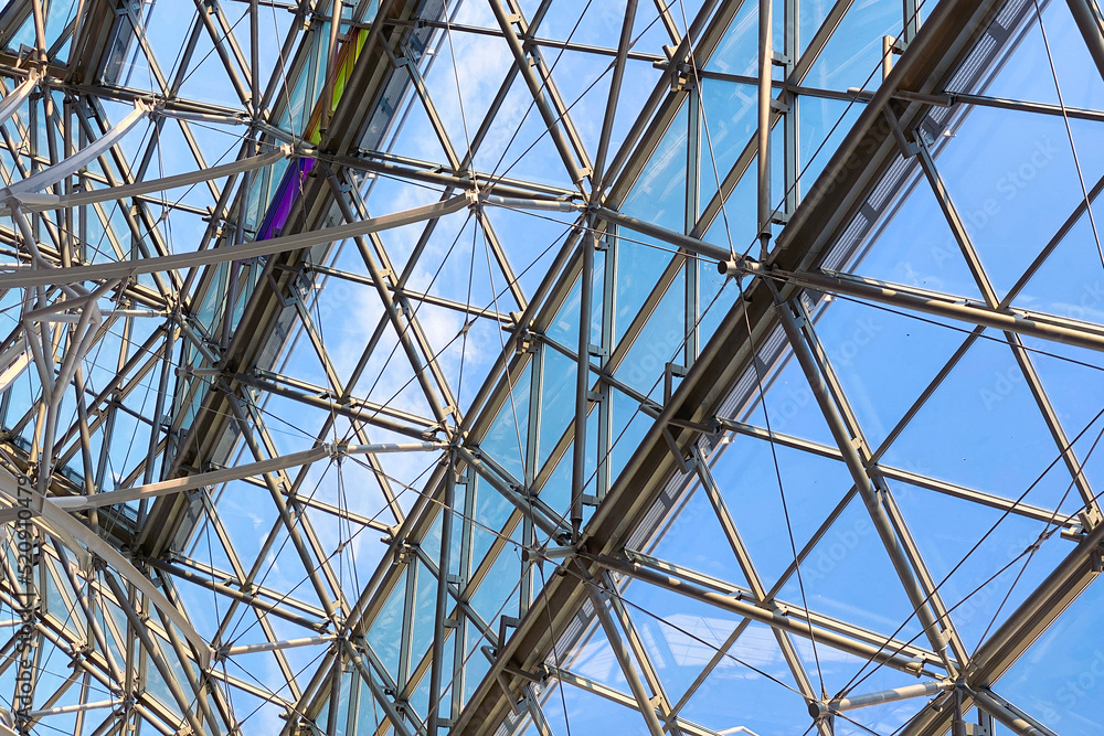 Geometric metal structure with glass, ceiling in a shopping center against the sky Geometric metal structure with glass, ceiling in a shopping center against the sky