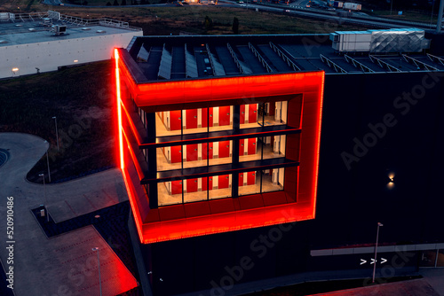 Red windows with neon illumination at night, a bright building in red, red windows and doors