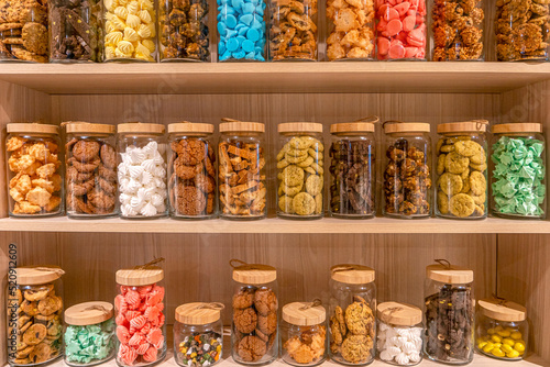 various of colorful, delicious and fresh cookies in jars for restaurant decoration 