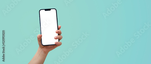 Fotografi cell phone in a woman's hand on a blue background - easy modification