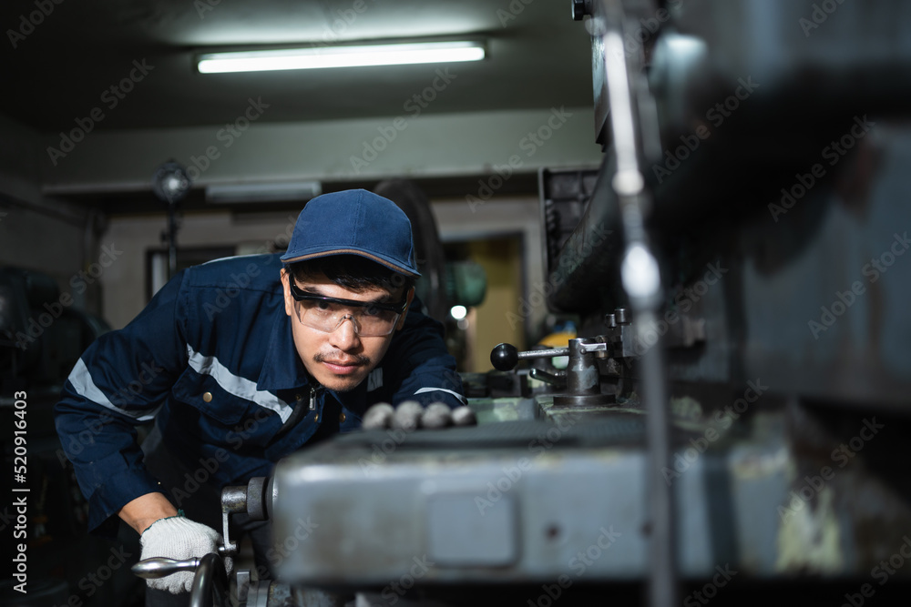 Engineer mechanical in safety suits working with grinding machine metal in the factory, Technician maintenance and check machinery, manufacturing steel industry. Engineer mechanical in safety suits working with grinding machine metal in the factory, Technician maintenance and check machinery, manufacturing steel industry.