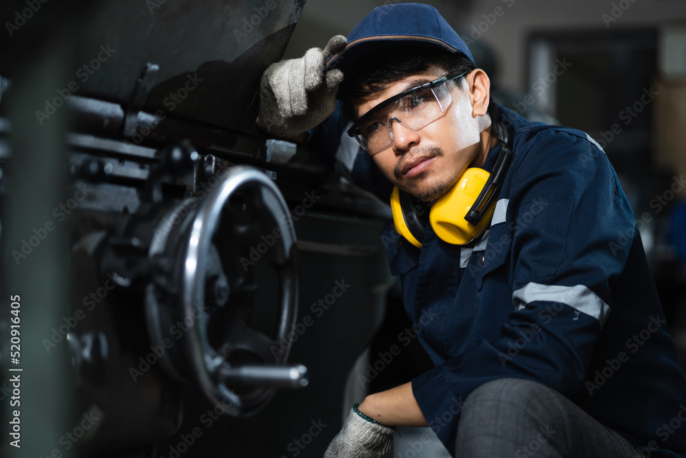 Engineer mechanical in safety suits working with grinding machine metal in the factory, Technician maintenance and check machinery, manufacturing steel industry. Engineer mechanical in safety suits working with grinding machine metal in the factory, Technician maintenance and check machinery, manufacturing steel industry.