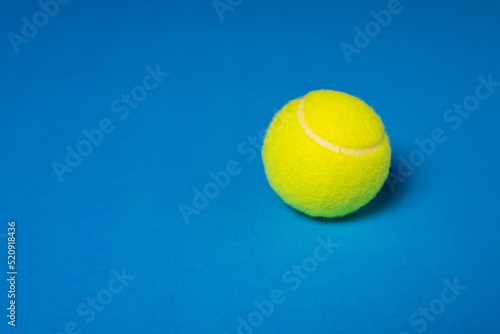 Tennis Ball With Copy Space on Blue Background  © Travis 